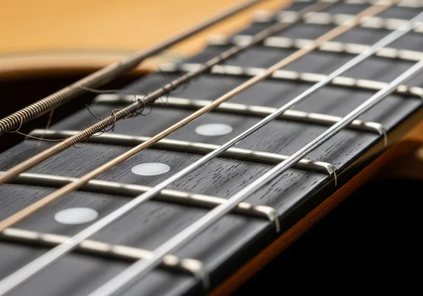 Guitar with old and new strings for comparison